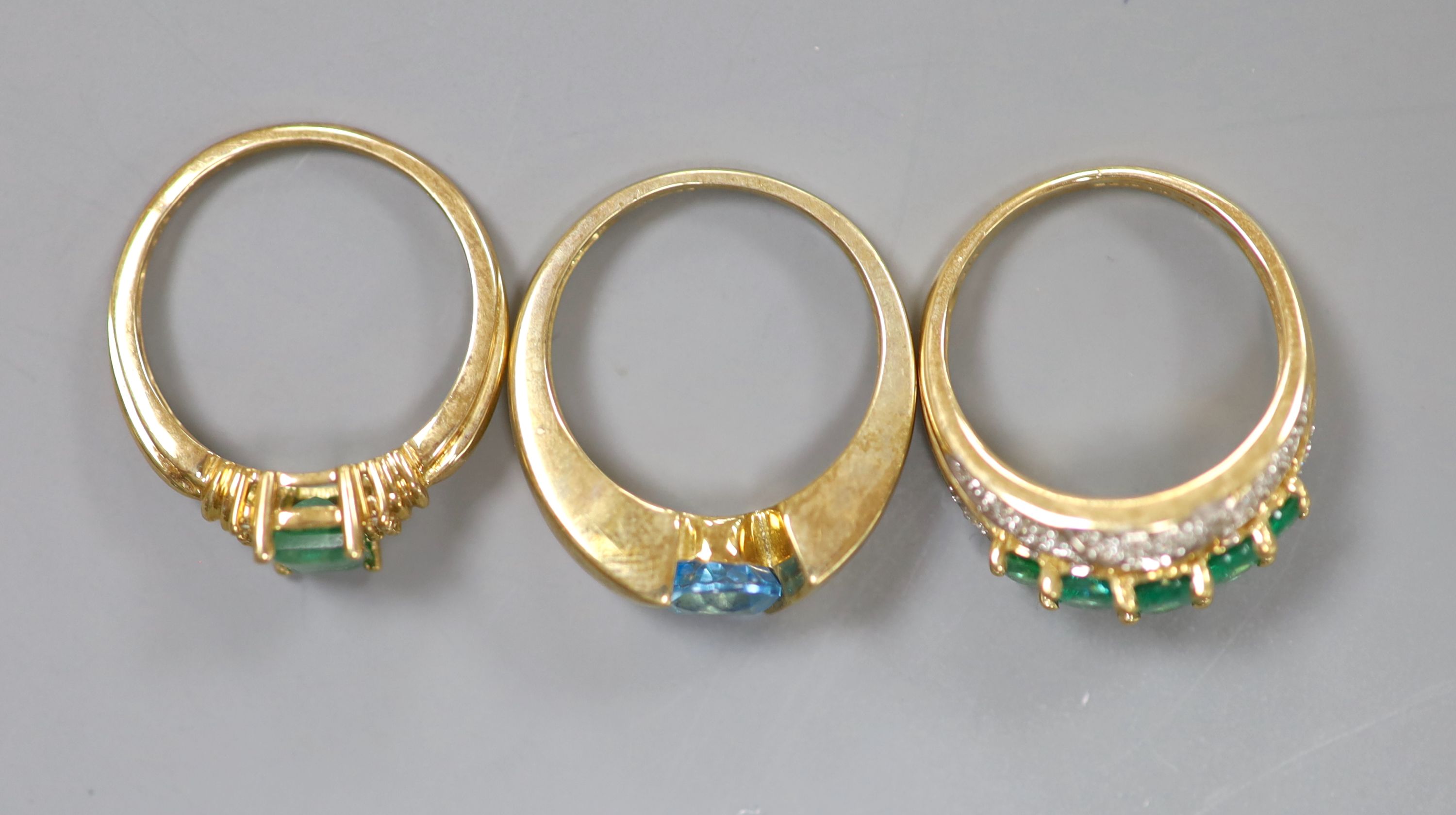 Two 9ct gold emerald-set rings and another 9k gem-set ring